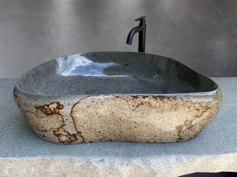 Polished grey stone sink with exterior in beige and oxidized tones